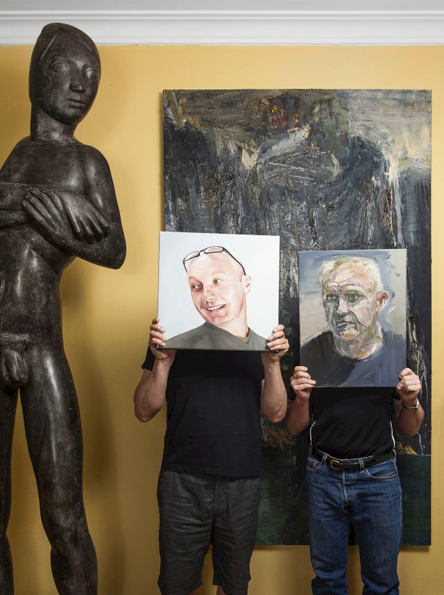 Michael Eyes and Gordon Elliott holding portraits by Juan Ford and Euan Macleod, with works by Terry Stringer (left) and Euan Macleod (back). Image: Christopher Pearce