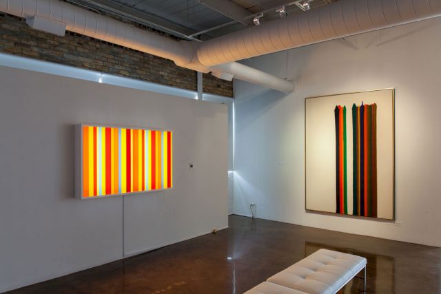 Installation view at Orange Door. (l–r) Spencer Finch, ‘Fire (After Joseph Wright of Derby)‘, 2009; Morris Louis, ‘Number 2-07‘, 1961. Photo: Joseph Rynkiewicz – © All Rights Reserved. Maryland College Institute of Art / VG Bild-Kunst, Bonn 2017