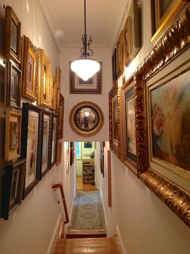 All works in this part of the hall are by James Gleeson and vary from works on canvas to works on panel and three works on paper. There are 21 works by James Gleeson in this image. The convex mirror at the end of the hall is decorative. Photogrpaher: Gordon Elliott