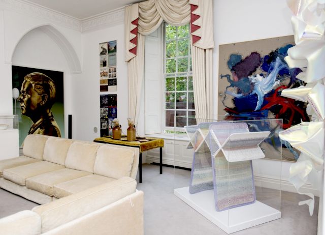 Palace Green, 2014; from the left: Aleksandra Domanovič, Portrait (mesing), 2012; Sharon Hayes, An Ear to the Sounds of Our History (Road to the White House), 2012; Francis Upritchard, Warm Table, 2011; on the wall: Ida Ekblad, Liquid drop of the Bleach, 2009; Haegue Yang, Non-Indepliable, Pastell, 2010. Photo by Camilla Greenwell