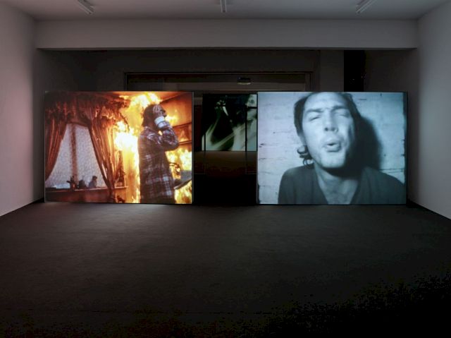 (l–r) REYNOLD REYNOLDS & PATRICK JOLLEY, Burn, 2001; PAUL MCCARTHY Spitting on the Camera Lens, 1974 (installation view). Photo Simon Vogel, Cologne