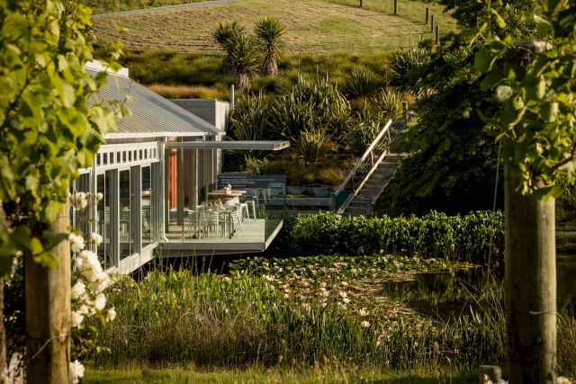 The Brick Bay Glass House restaurant, cantilevered over the lake and lilypads.
