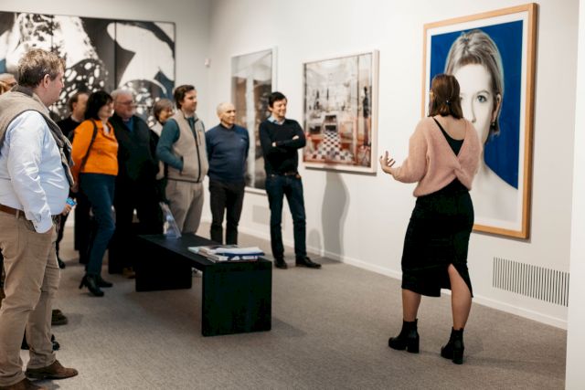 Marie Tuytens speaks in front of works from the collection, including Cai Dongdong, Offer, 2010, and Marie Jo Lafontaine, Babylon Babies N°8, 2001. Photo by Mahira Benizem